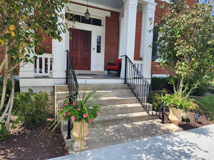 Classic custom metal porch handrail on a brick Nashville home