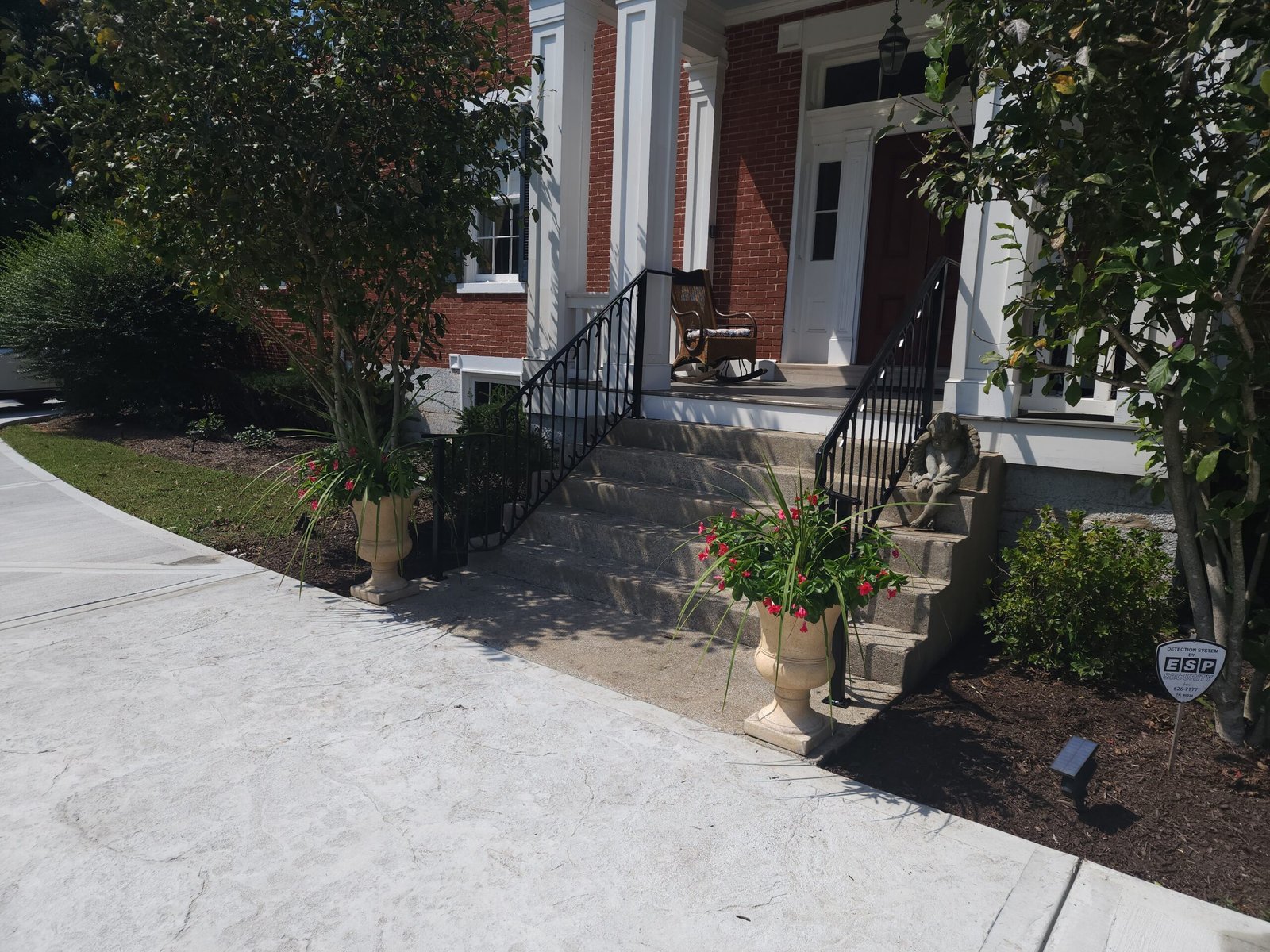 Custom iron handrail on brick front steps of a Franklin TN home