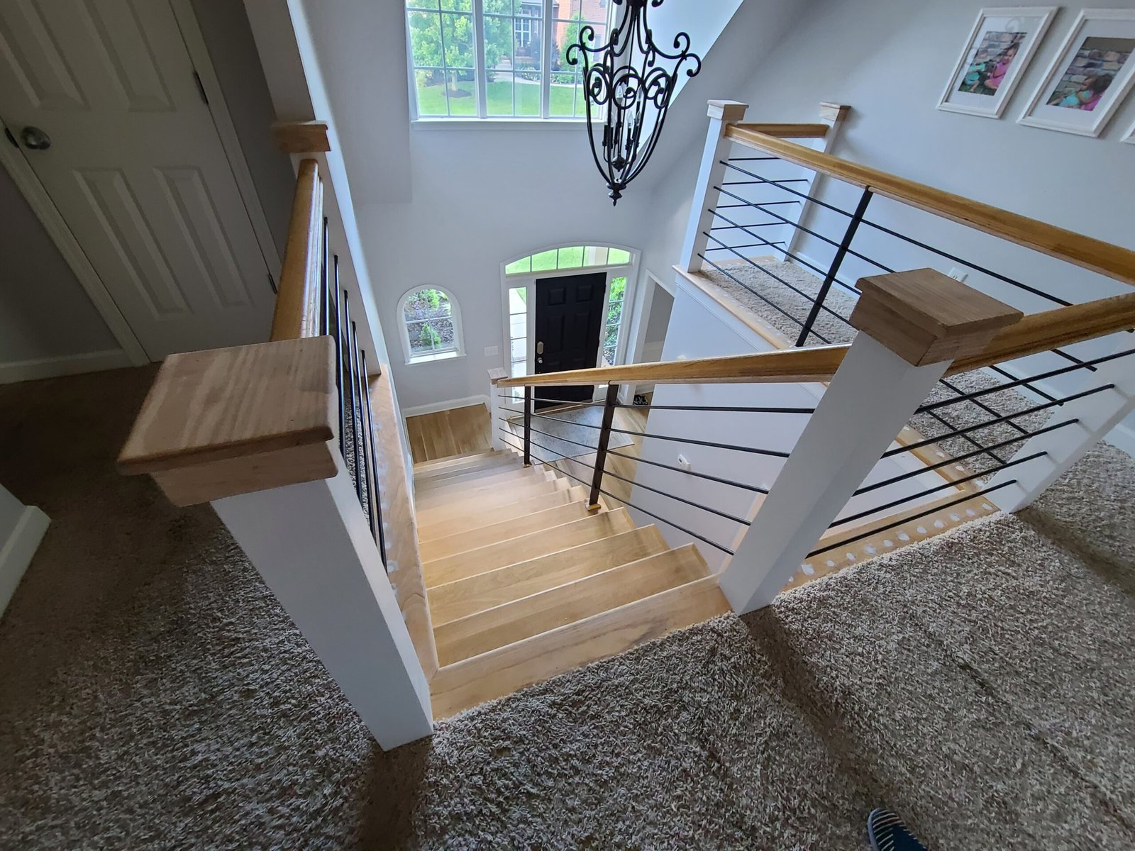 Grand foyer staircase with custom wood and steel cable railing in a Brentwood TN home