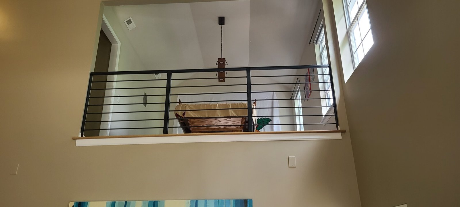 Modern loft cable railing overlooking the living space of a Tennessee home