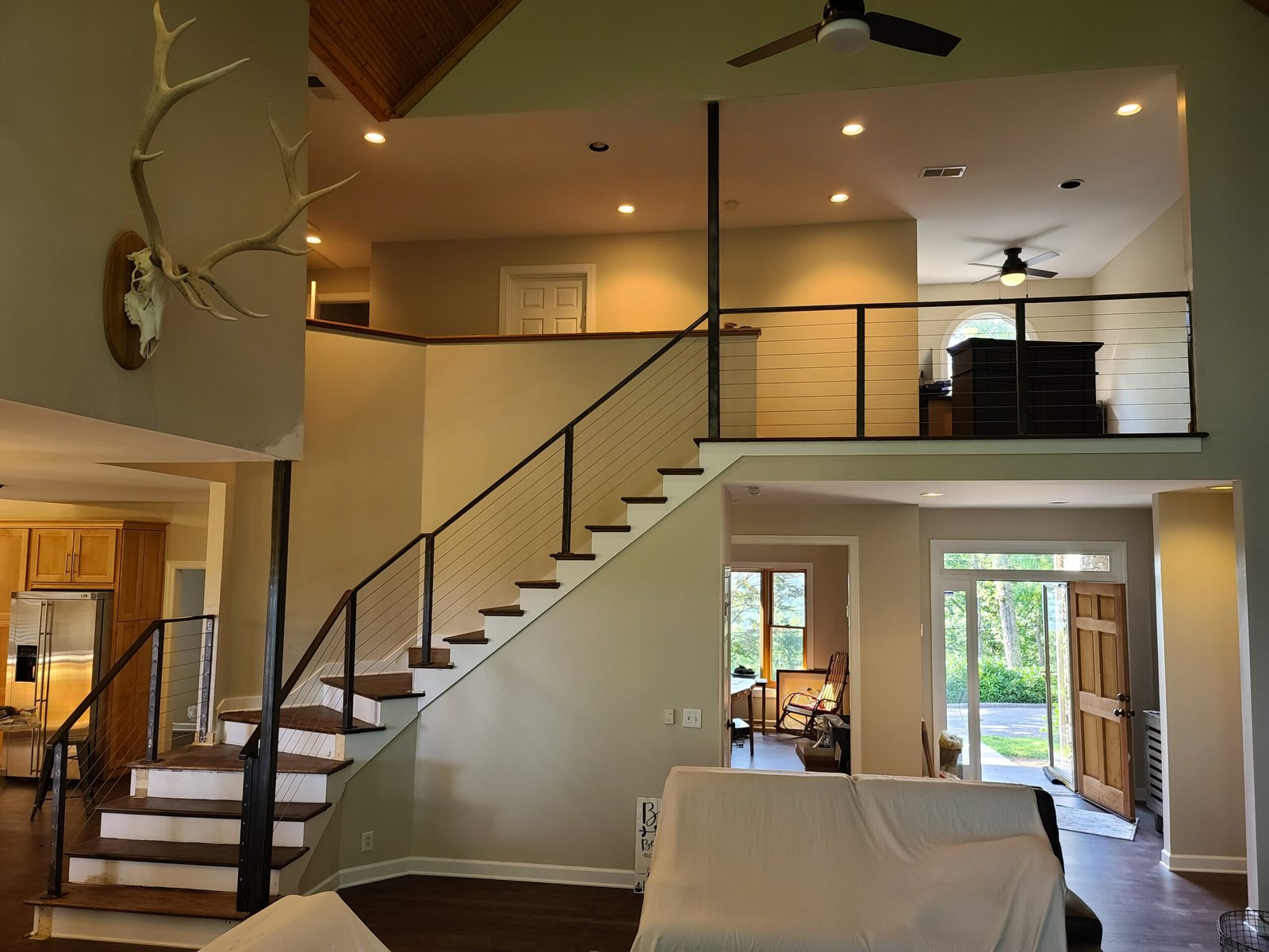 Open concept staircase with custom cable railing in a vaulted Middle Tennessee living room