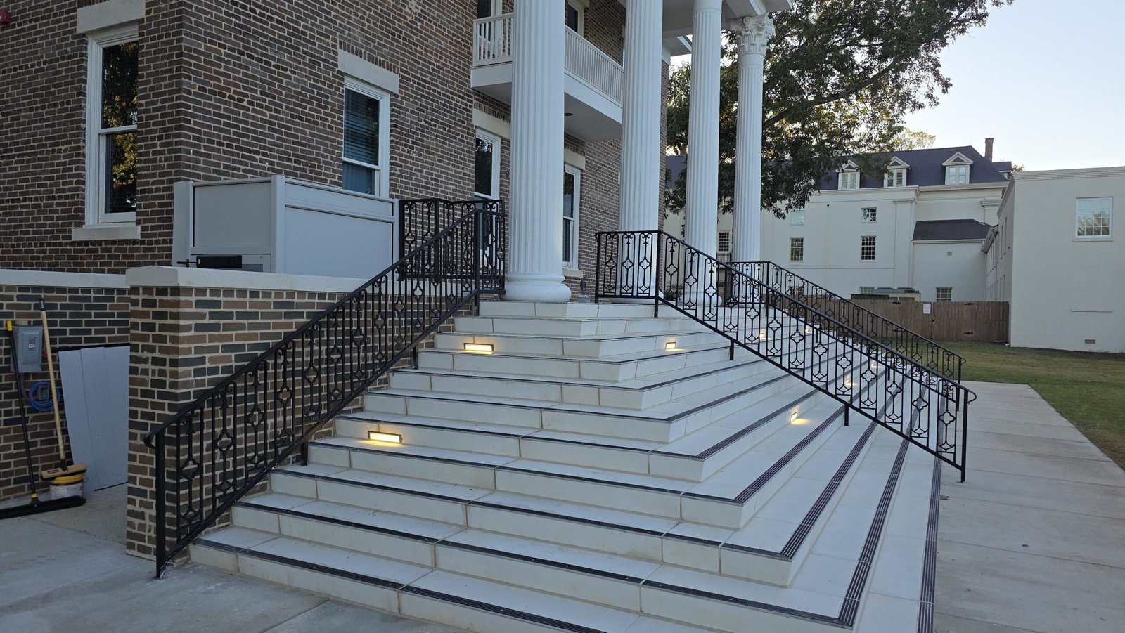 Hand forged ornamental railings on the grand columned entrance steps of a historic Franklin TN building